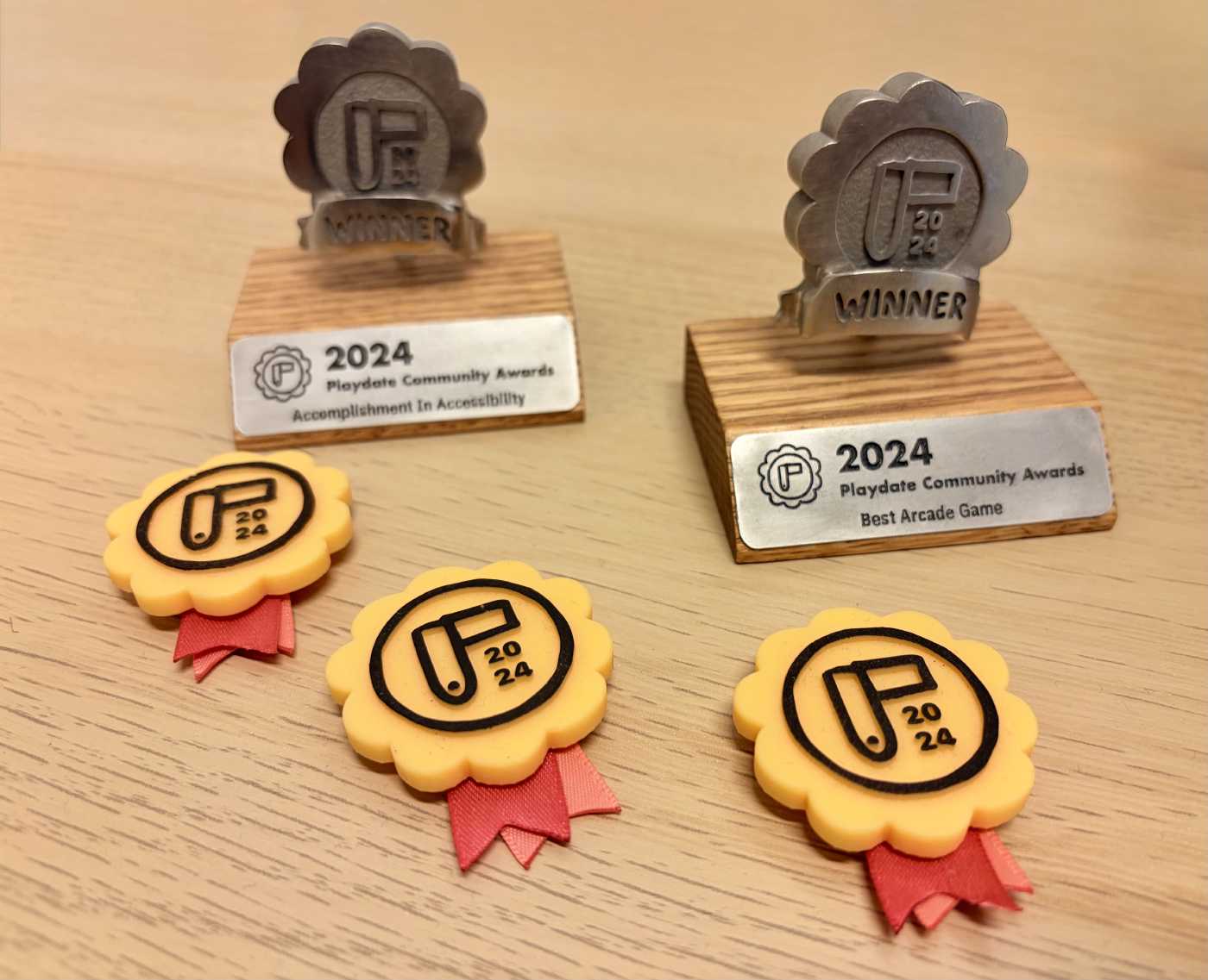 Two awards and three nomination badges